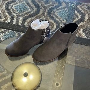 Gray low cut boots with side zipper.